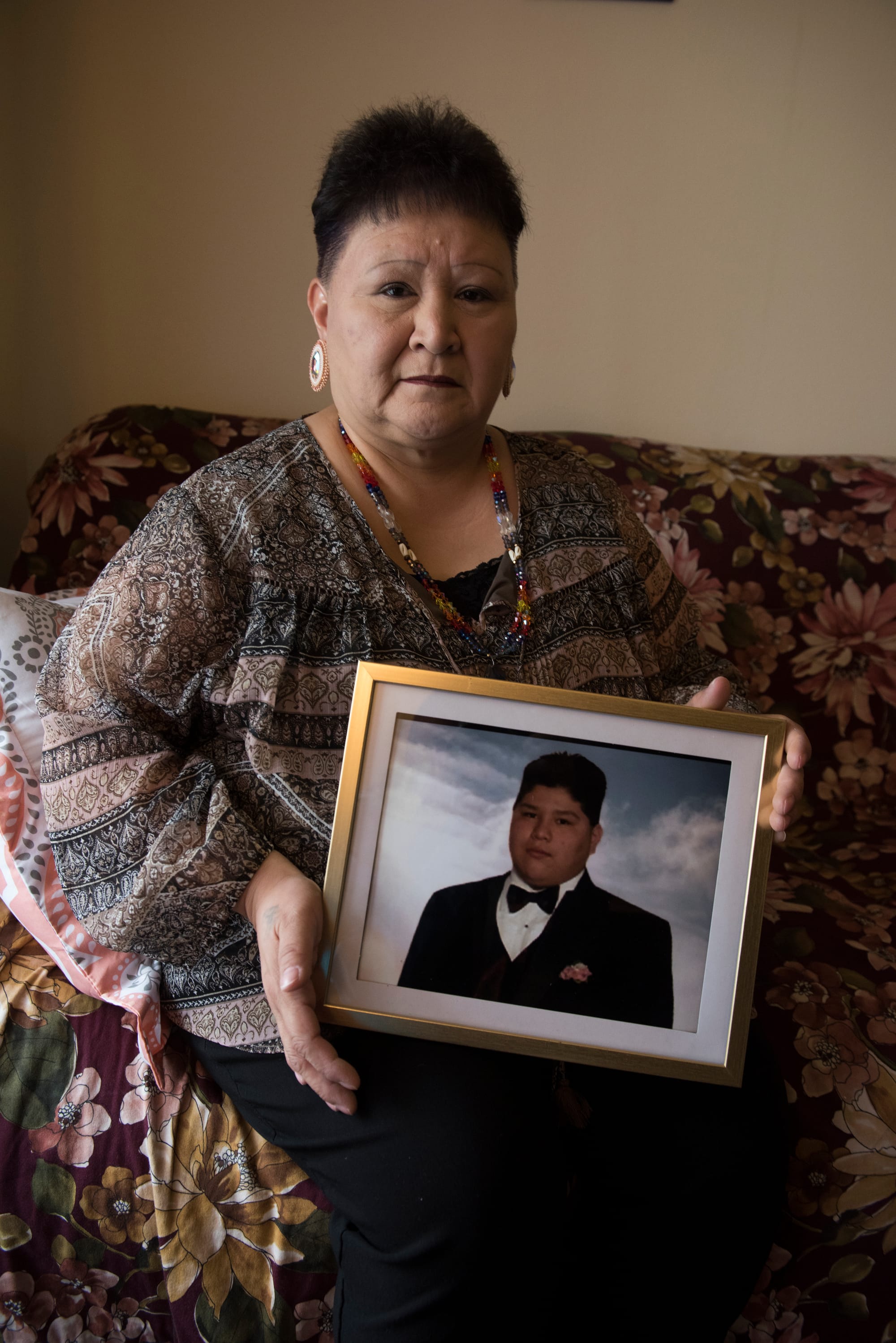 Willeena George holds a prom photo of her son Domonique Nappo