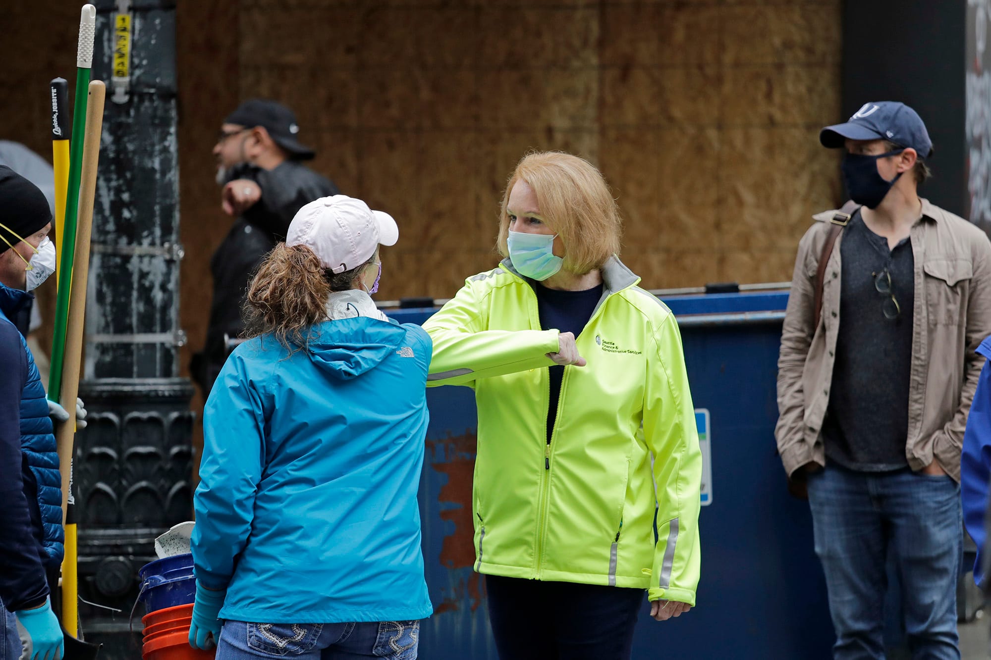 mayor durkan gives someone a forearm high-five