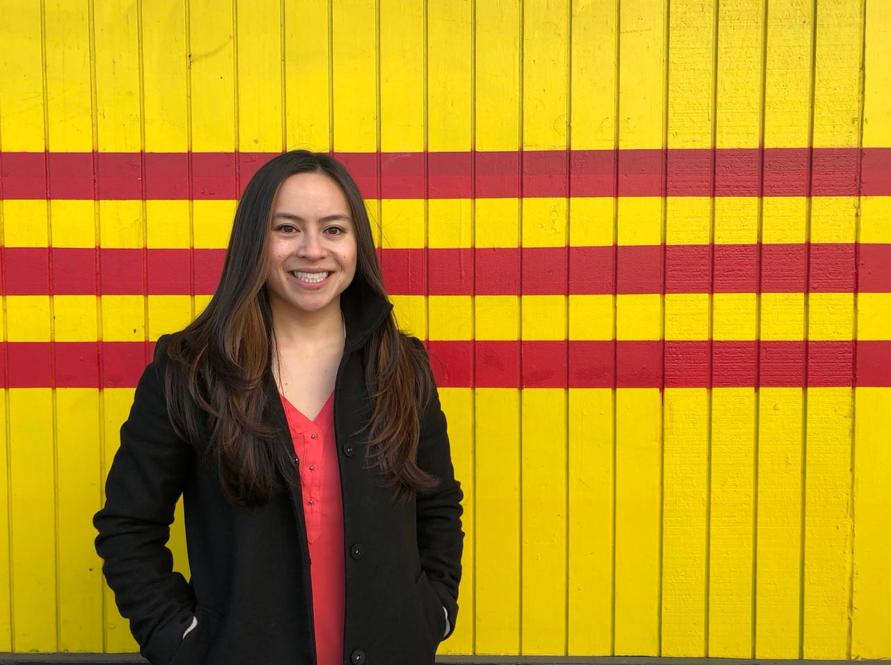 Ami Nguyen, who is mentioned in the story. She is standing outside one of her favorite Seattle Vietnamese restaurants, Pho Bac, in Little Saigon.