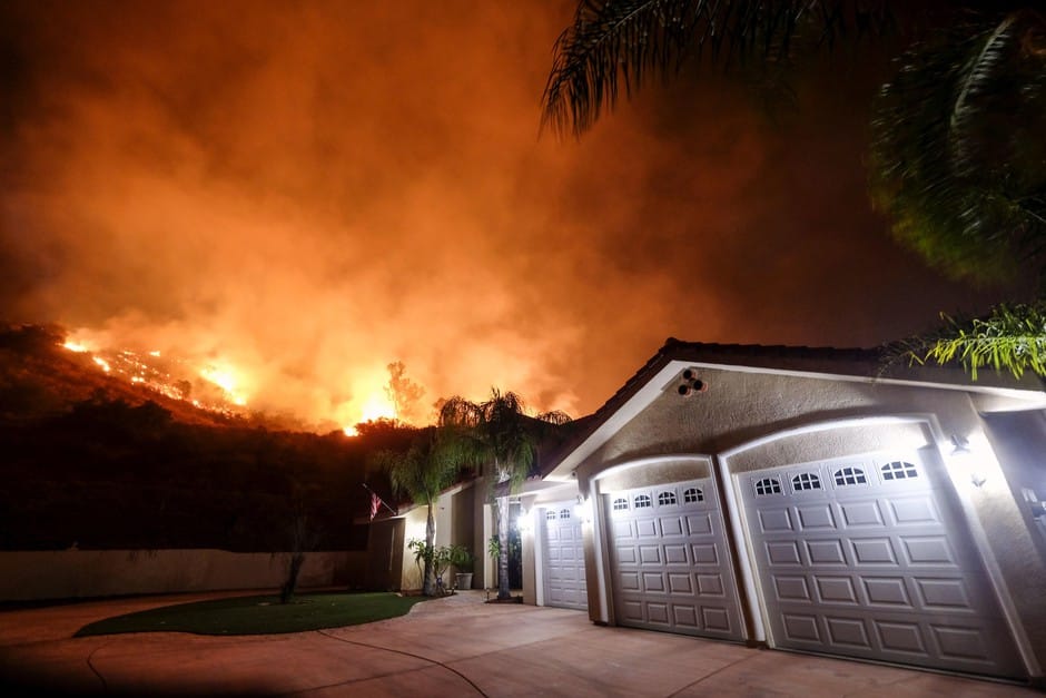 Flames shoot from a home in Lake Elisnore, Calif.