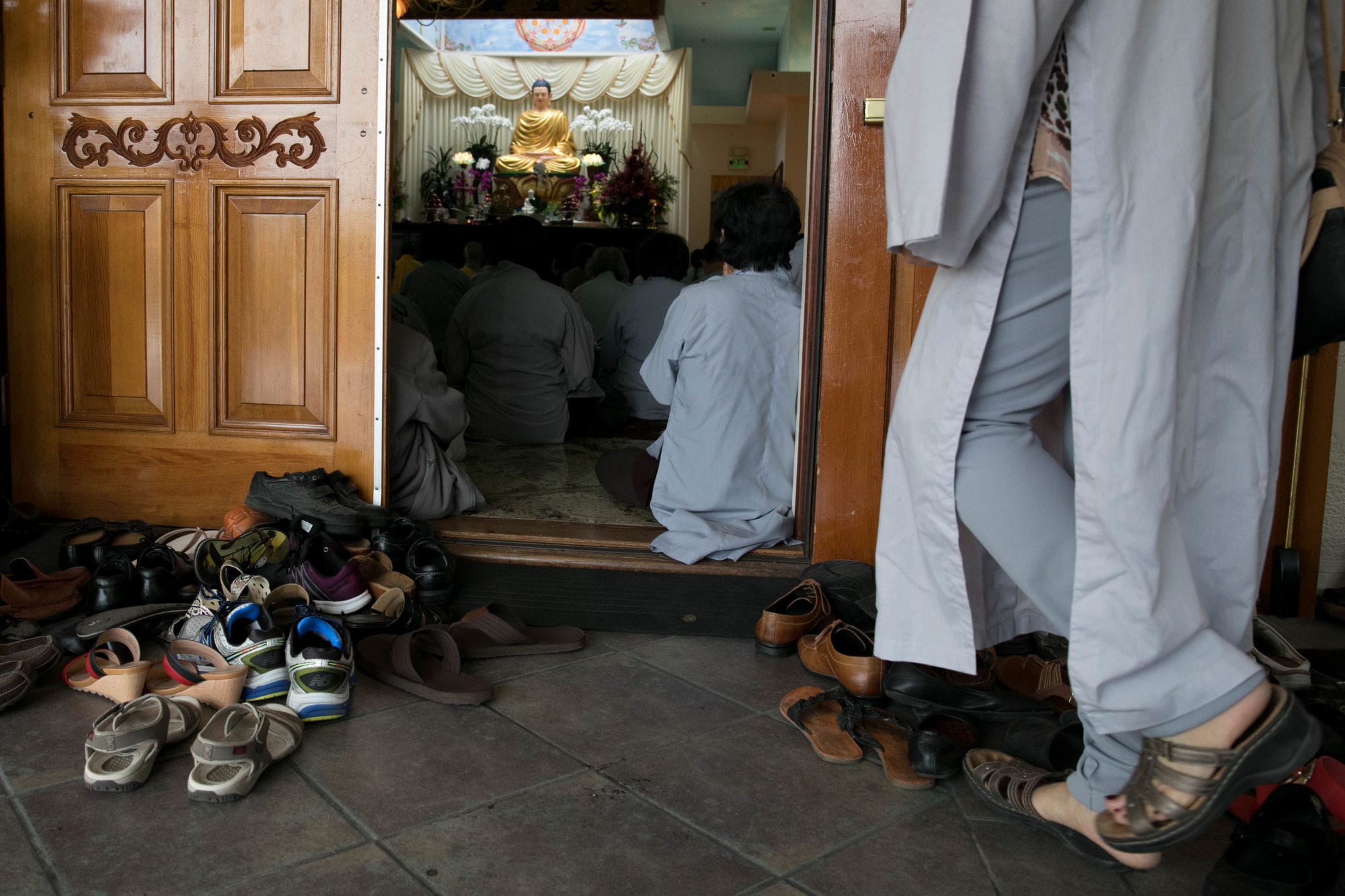 A visitor is seen removing her shoes