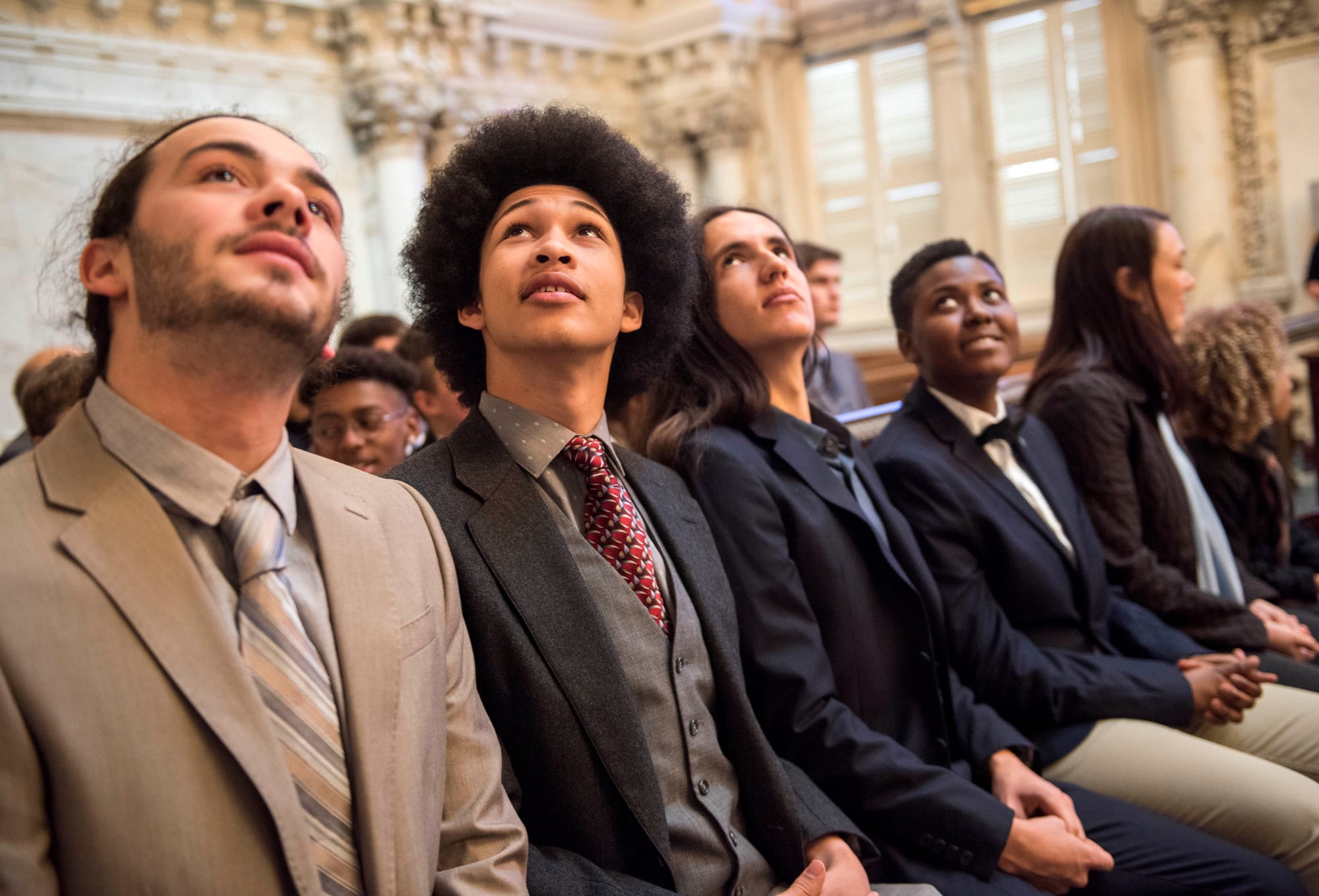 Juliana plaintiffs in suits wait in a courthouse. 