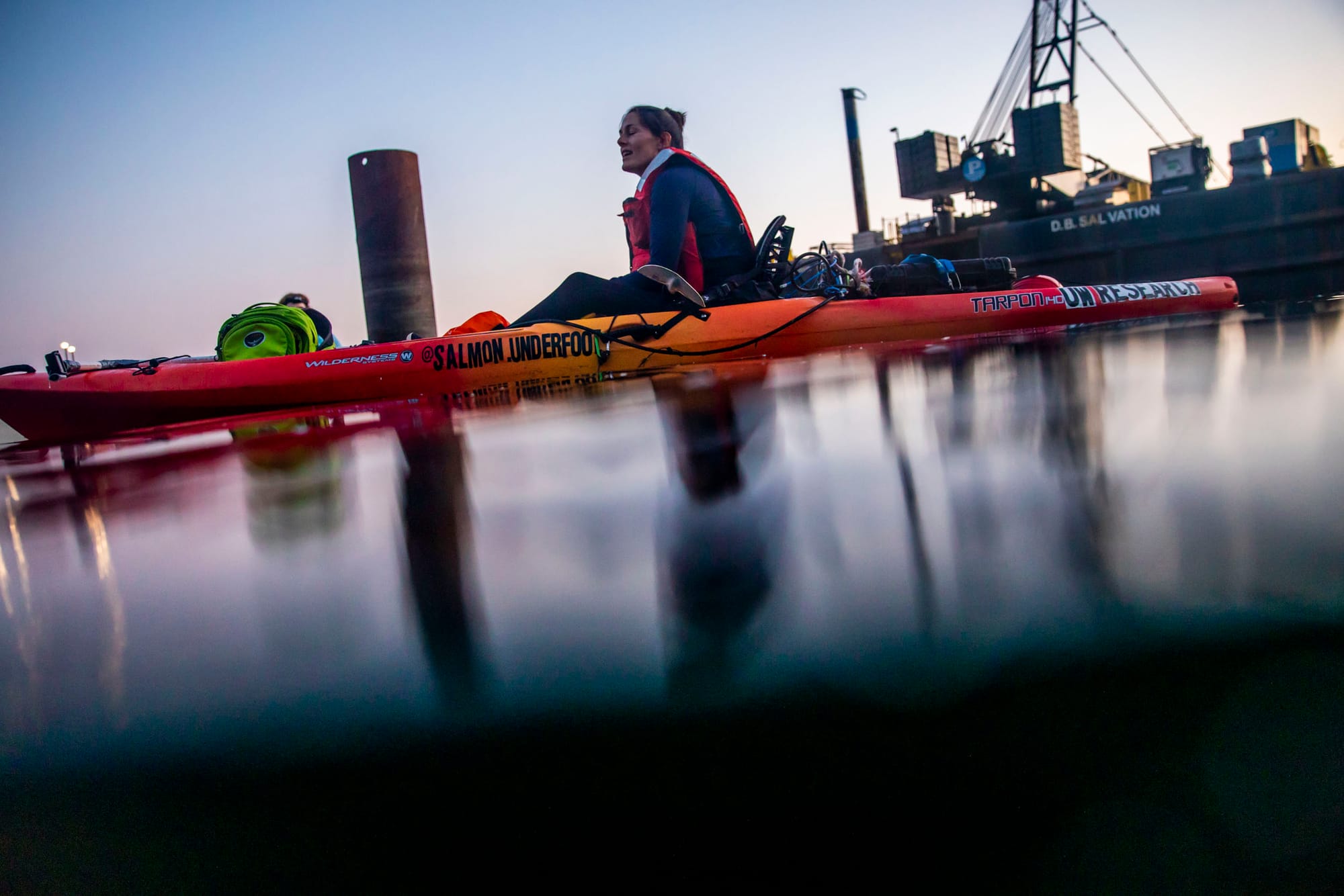 Woman in kayak at sunset