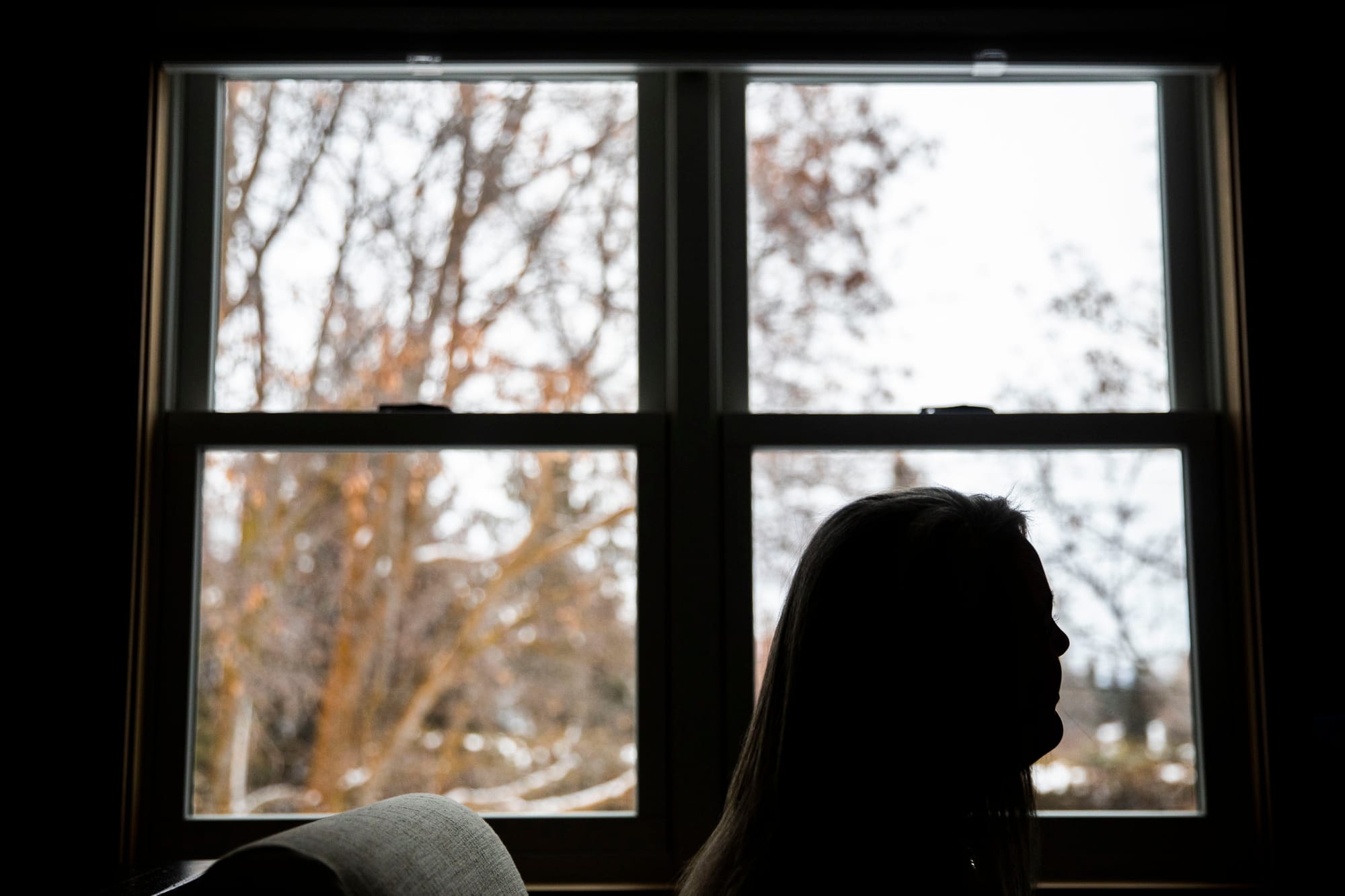 Woman looks out window