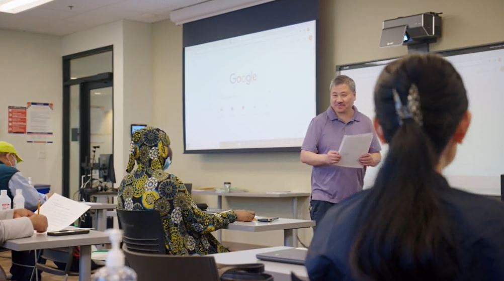 A man teaches in front of students