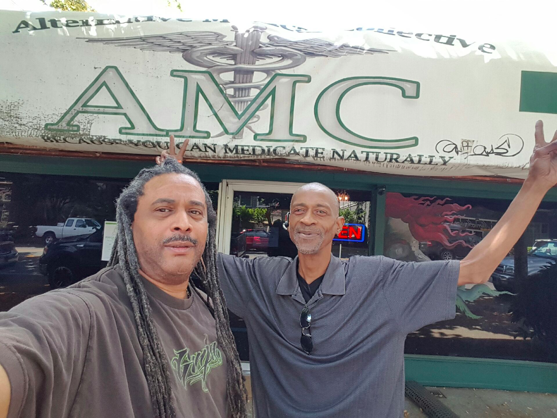 Reginald White and a friend outside of his dispensary.