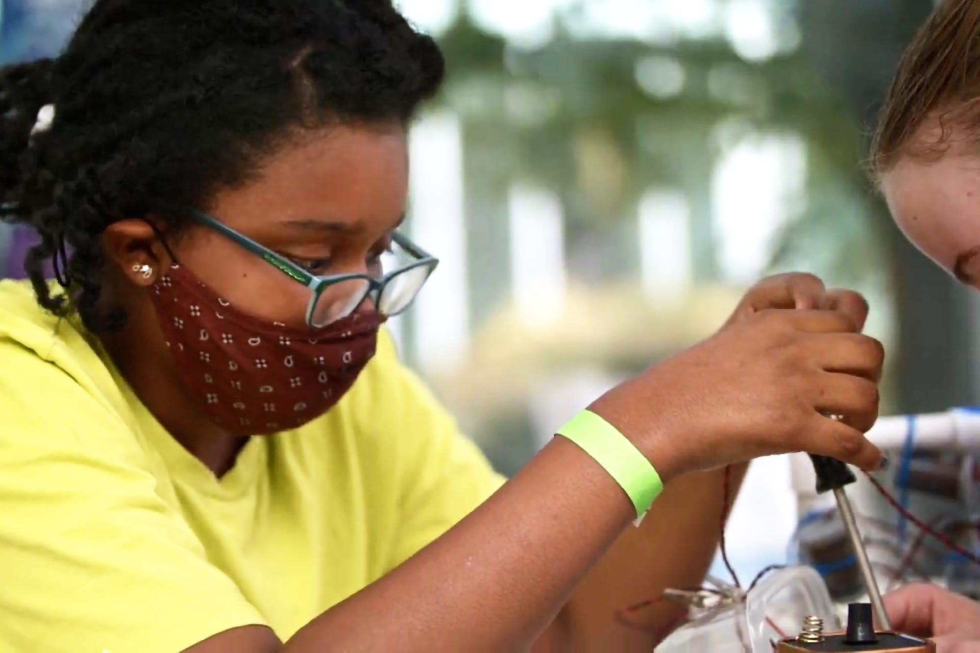 A youth at PacSci works on a science project