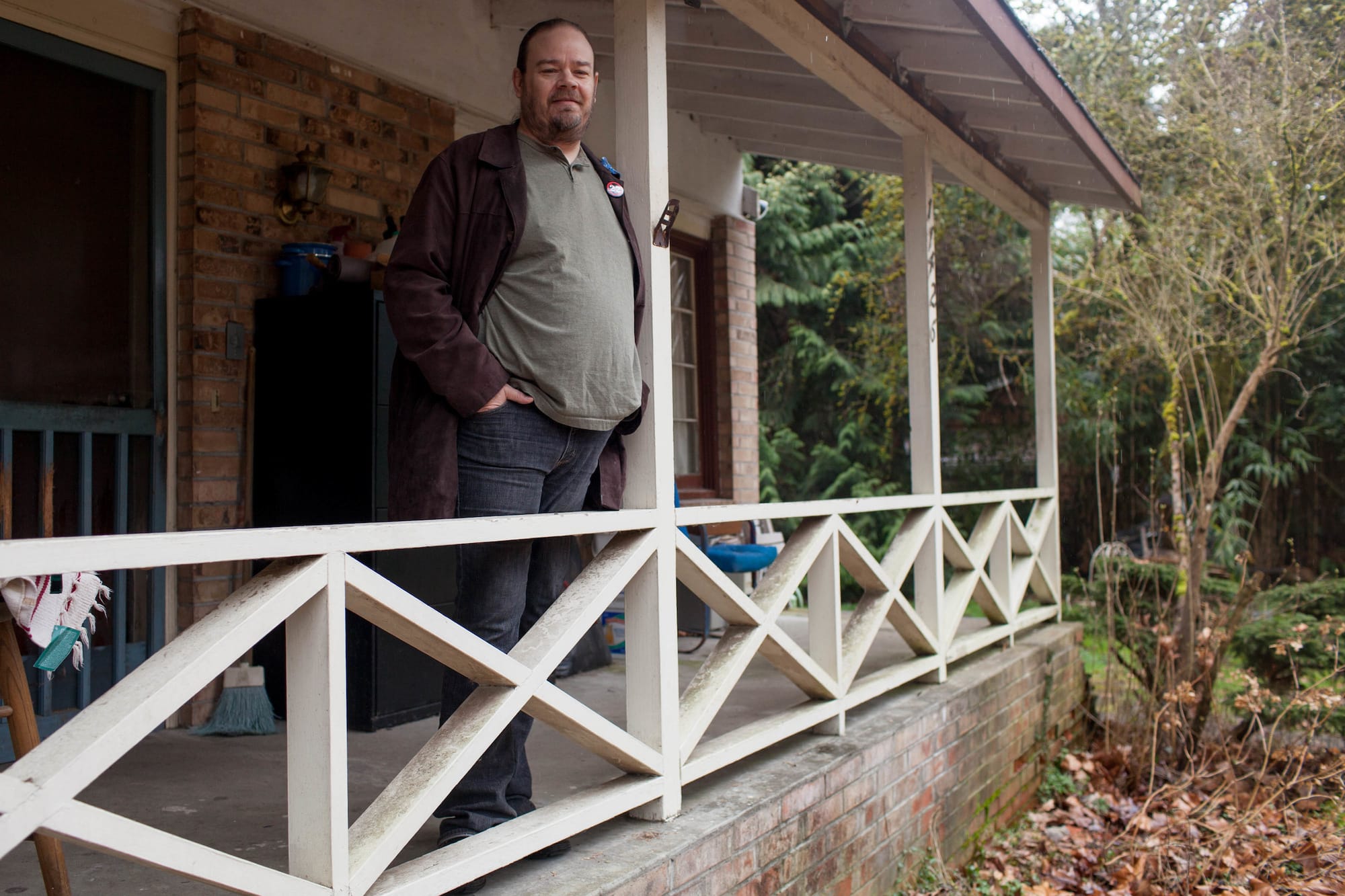 John Novak standing on the front porch of his home.