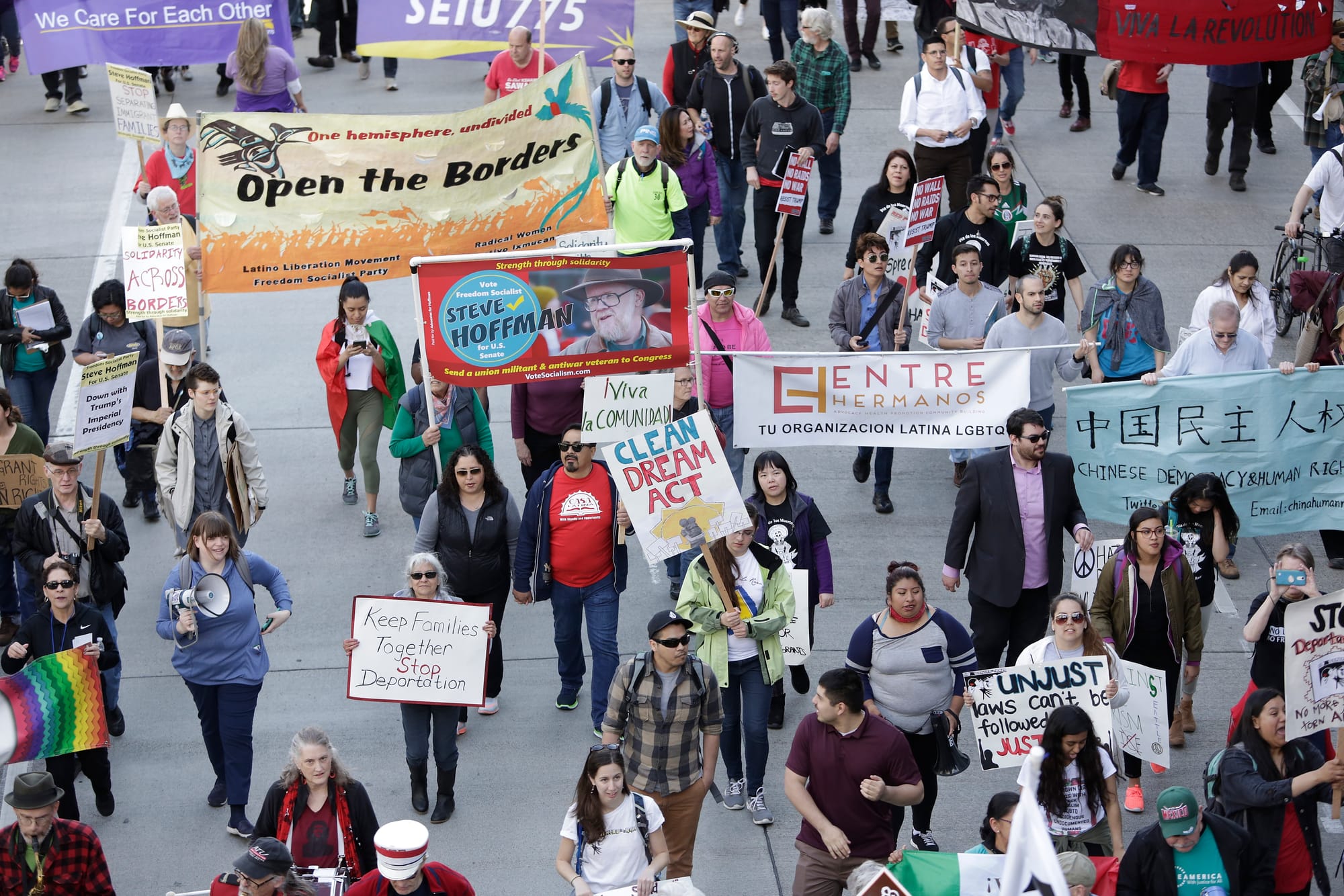 People march down 4th Avenue South during the annual May Day March for Workers and Immigrant Rights in Seattle, May 1, 2018. (Jason Redmond for Crosscut) 