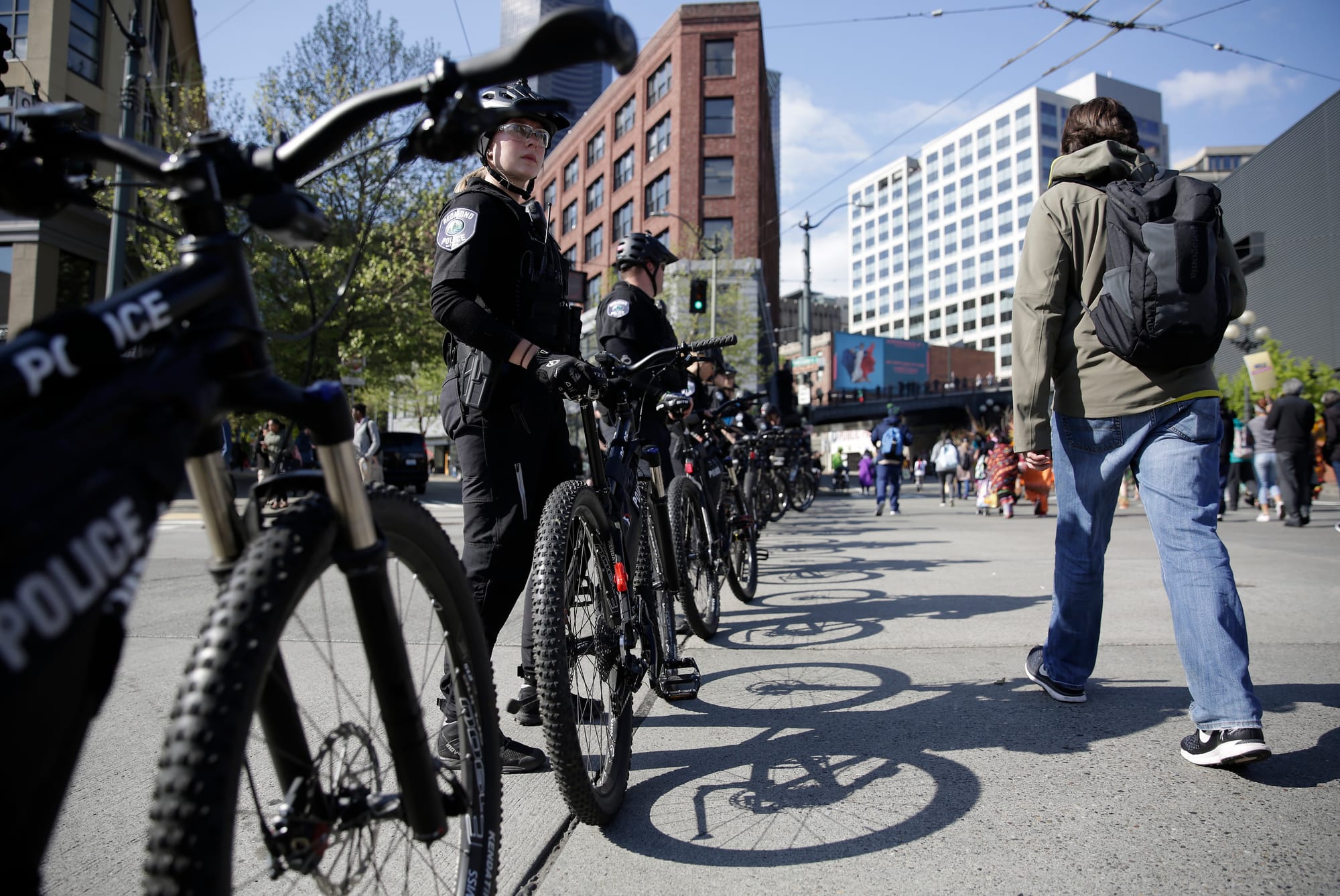 Bicycle officers from multiple departments monitor the annual May Day March for Workers and Immigrant Rights as it progresses along 4th Avenue in Seattle.