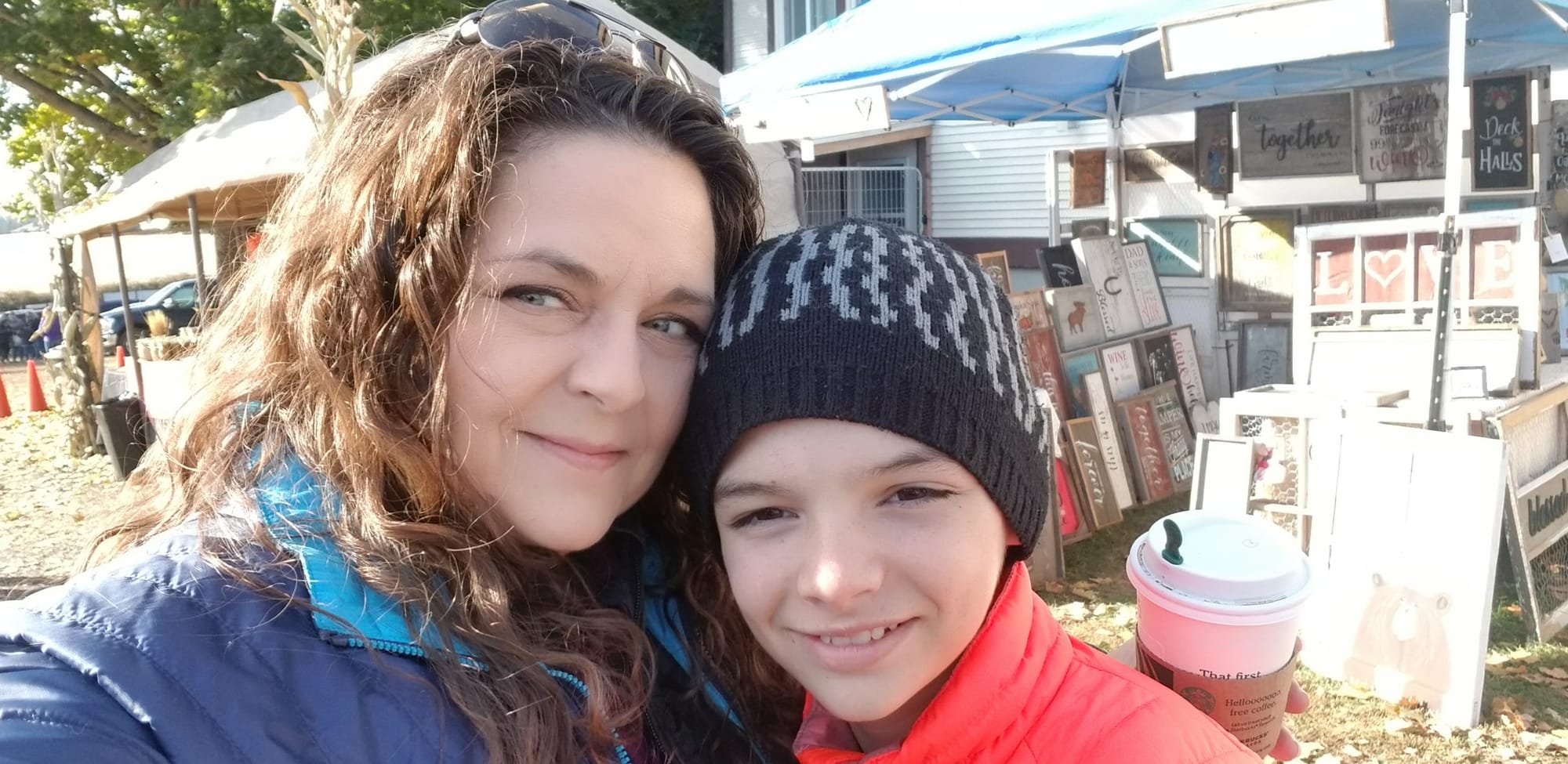 Angela Lucky stands with her son outside