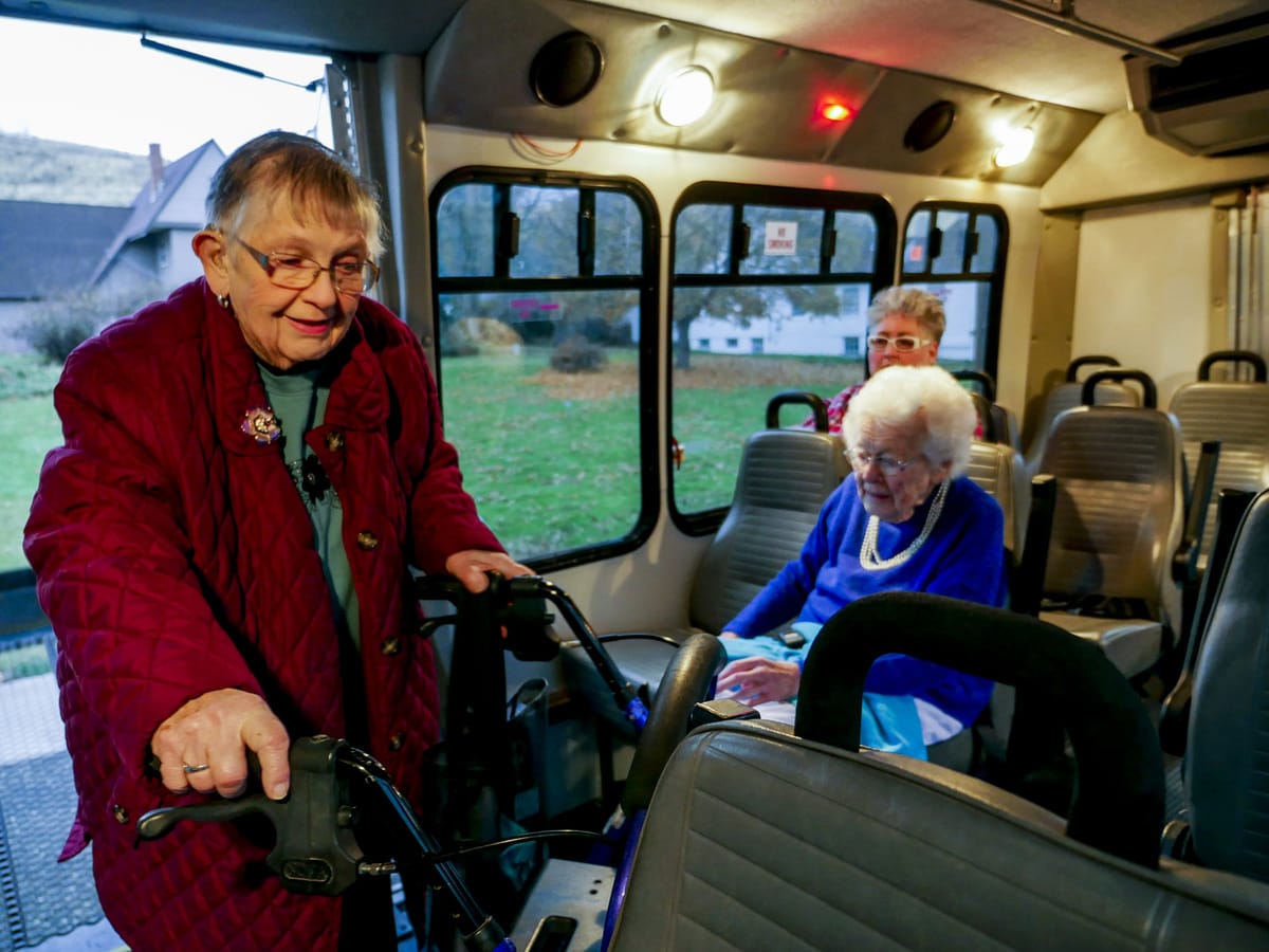 From the inside of a transit van, a woman is seen entering