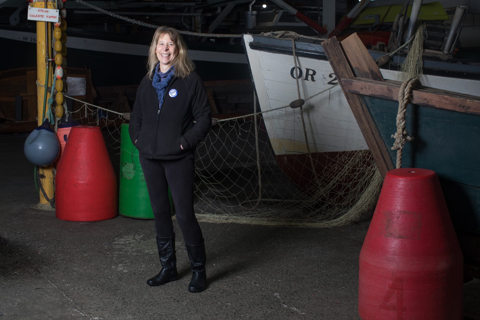 Holly Hughes of Indianola, Washington stands for a portrait inside the cannery building on historic Pier 39 in Astoria.