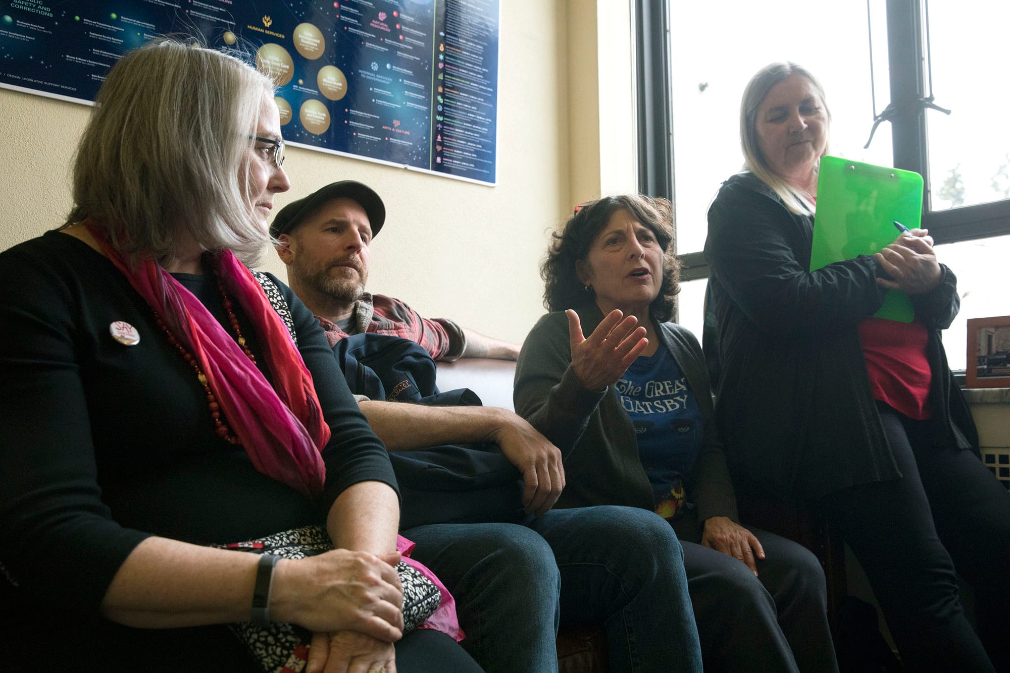 Lee Micklin of Cleveland STEM High School (center right) sits with other librarians and talks with Washington state Sen. Reuven Carlyle during a group lobbying effort at his Olympia office, April 2, 2019. (Photo by Matt M. McKnight/Crosscut)