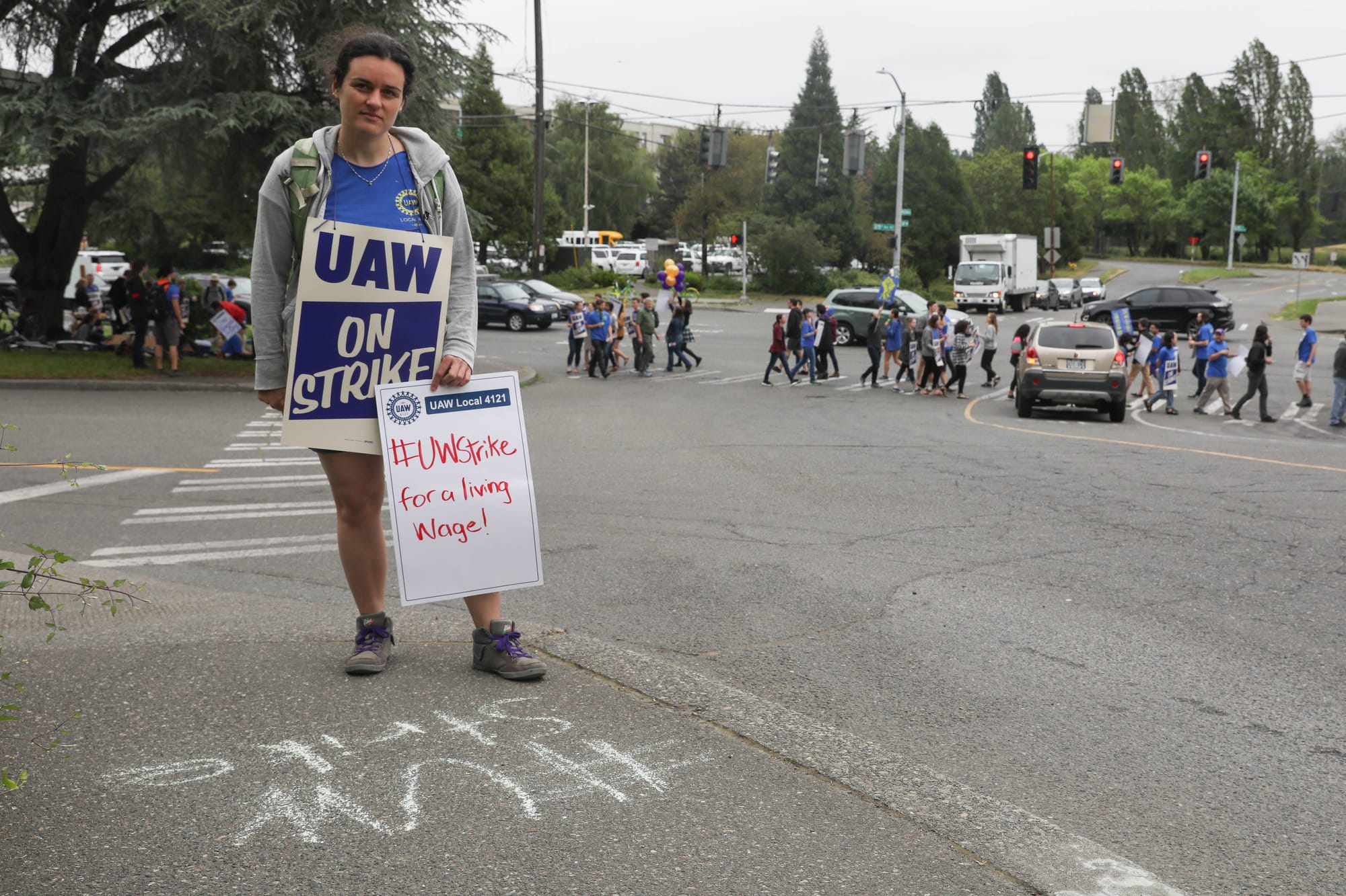 Emily Willard stands near the corner of Pend Oreille Street and Montlake Boulevard NE during a one-day strike with graduate students who are represented by UAW Local 421 at the University of Washington in Seattle, May 14, 2018.