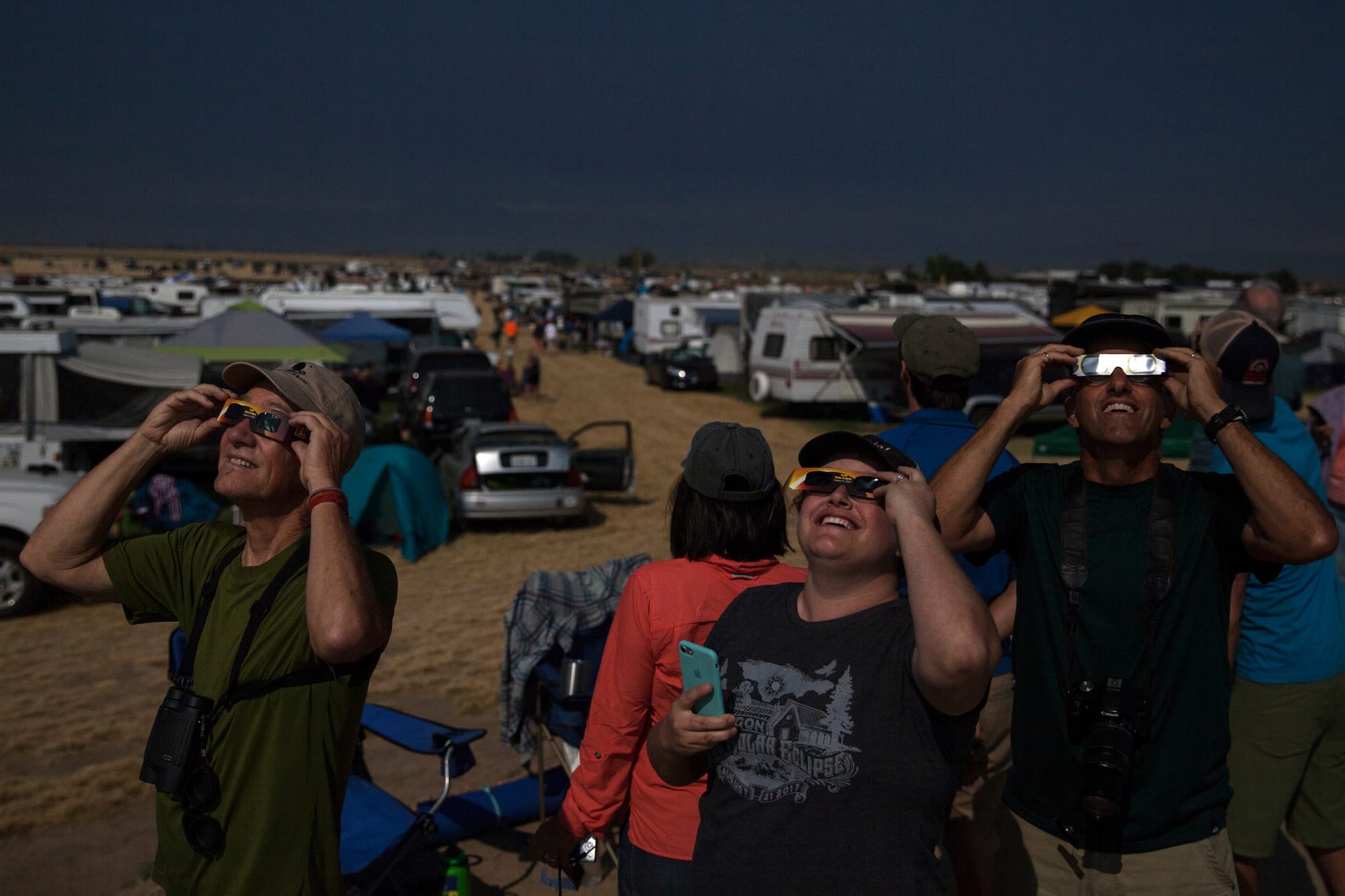 people with eclipse-watching glasses