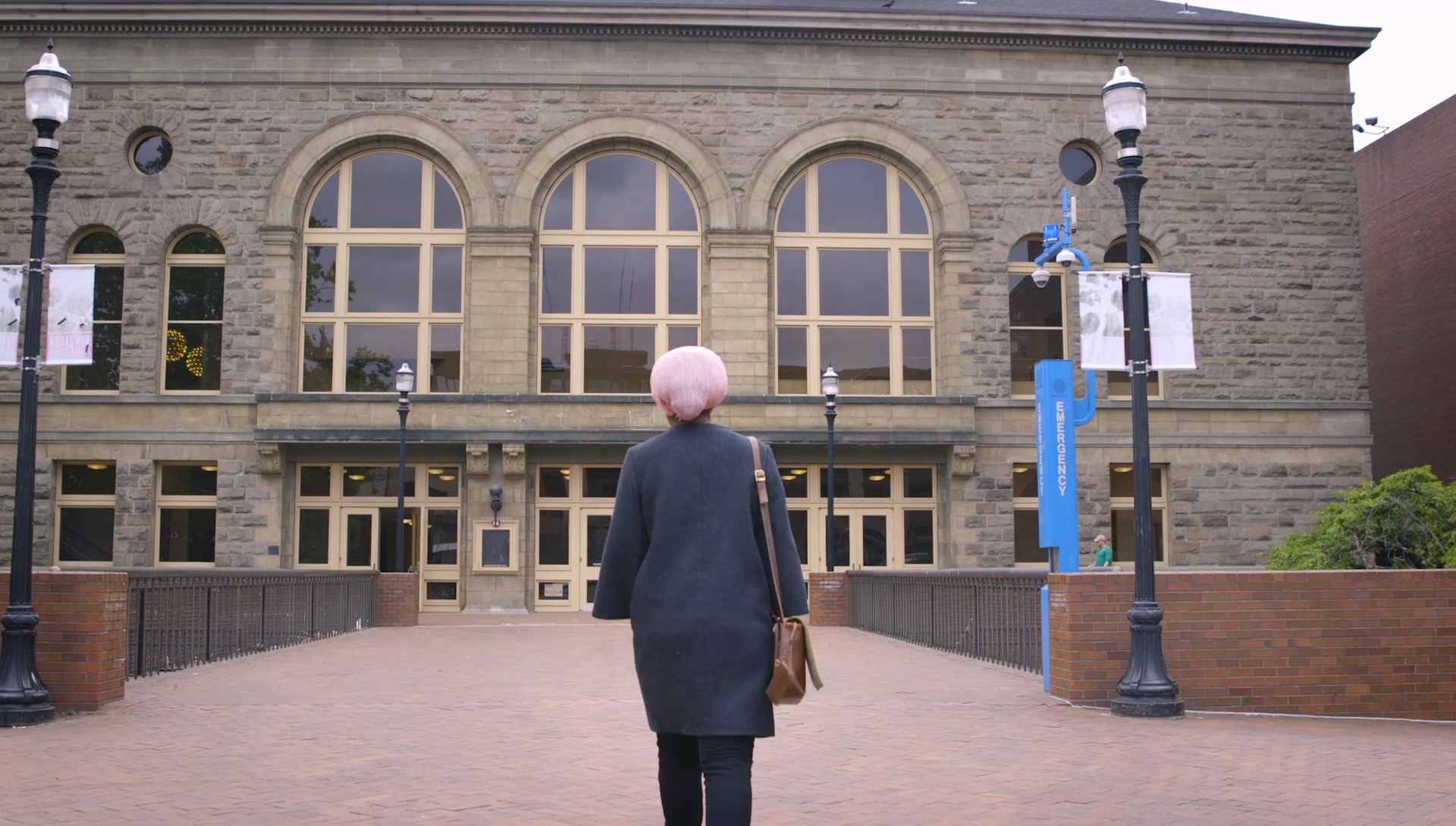 Woman walking into building