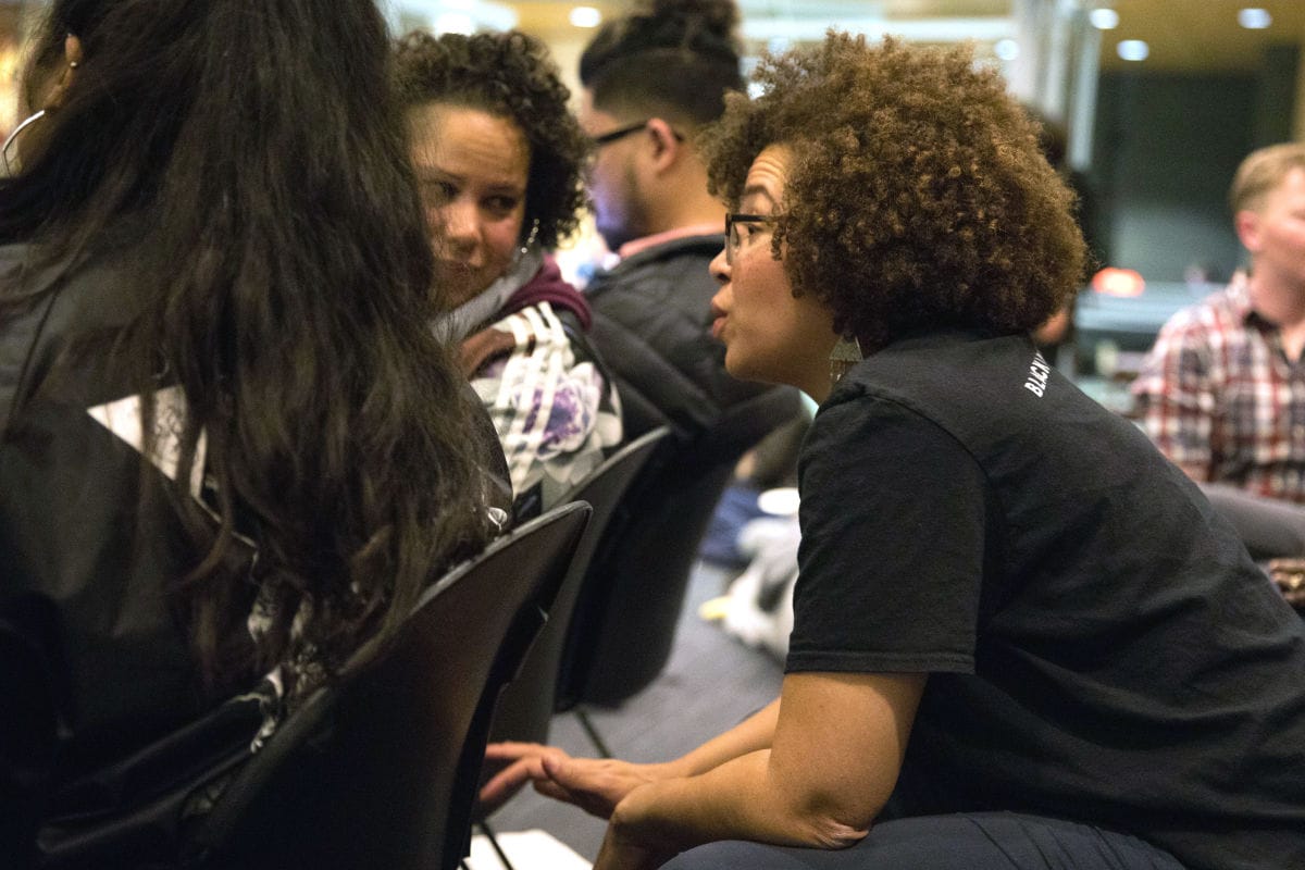 Harris-Talley sits with former mayoral candidate Nikkita Oliver and throngs of other activists in the Bertha Knight Landes room of Seattle City Hall.
