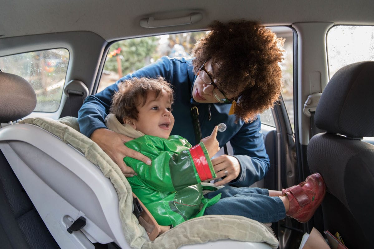 Harris-Talley loads her son Malcolm, 2, into the family car as she prepared to take her daughter Cora to elementary school in Columbia City.