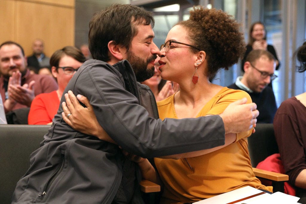 As the City Council announces Harris-Talley has been appointed to the interim at-large Position 8 seat, her husband Jason leans in to give her a congratulatory kiss.