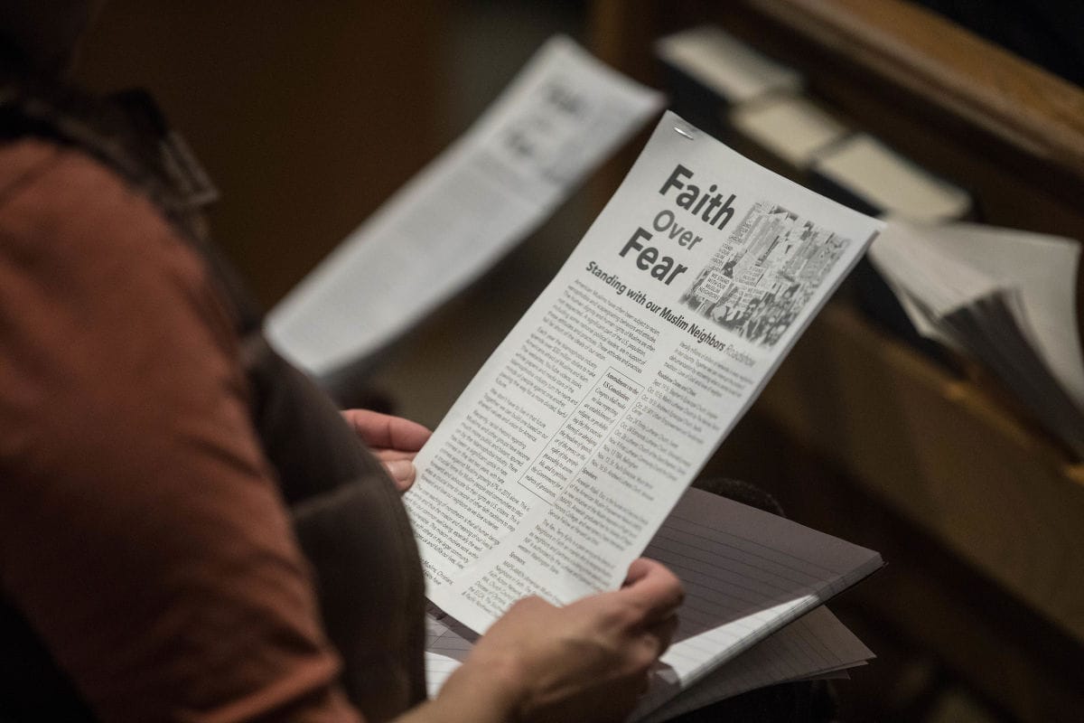 A visitor holds a program for 'A Faith Over Fear Roadshow' while at St. Paul’s Episcopal Church in Mt. Vernon.