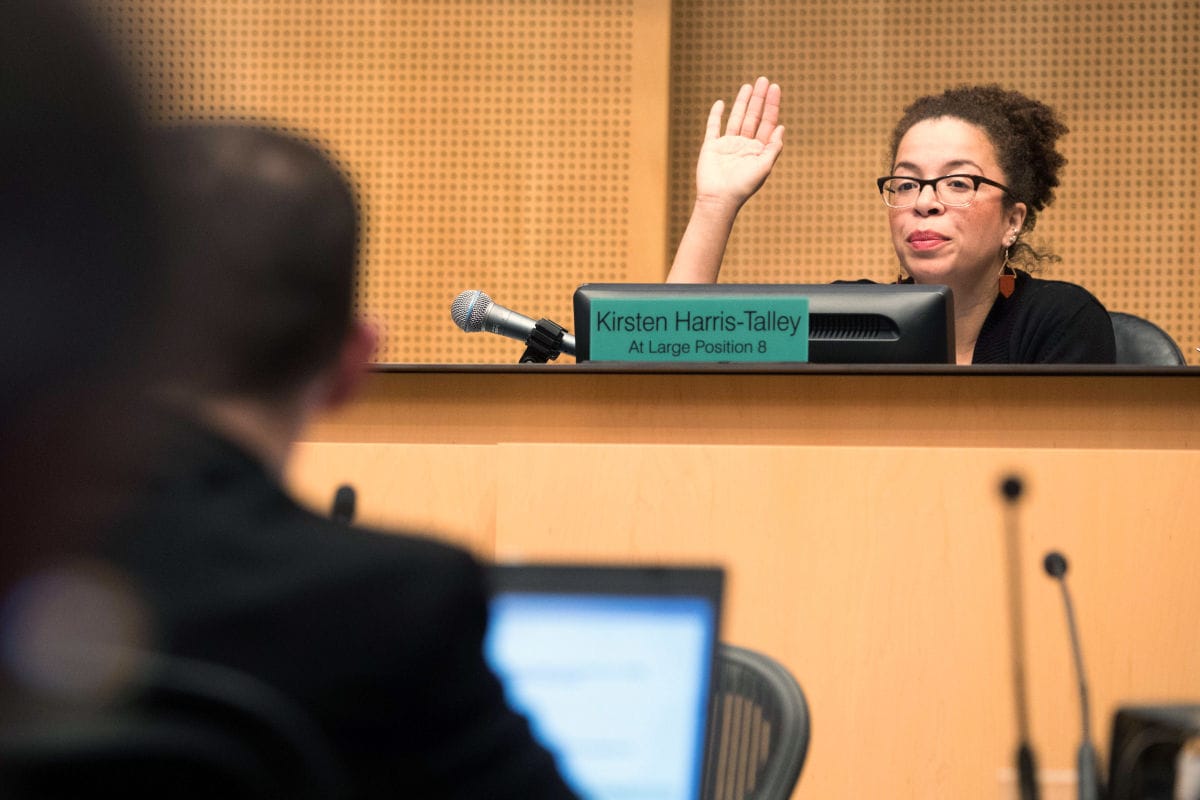 Harris-Talley raises her hand and votes to pass the city's 2018 budget.