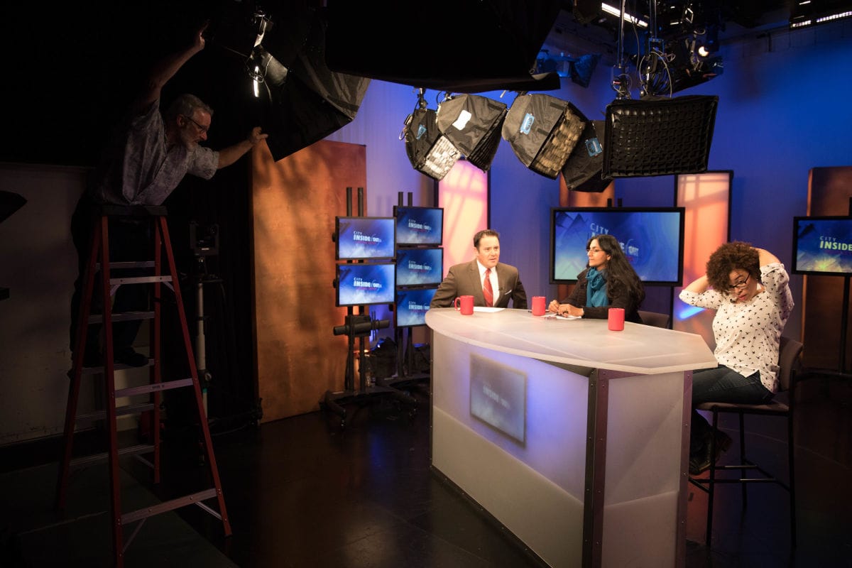 Harris-Talley and Councilmember Kshama Sawant sit at a desk before being filmed for an episode of City Inside/Out: Council Edition with host Brian Callanan at the Seattle Channel’s studios at Seattle City Hall.