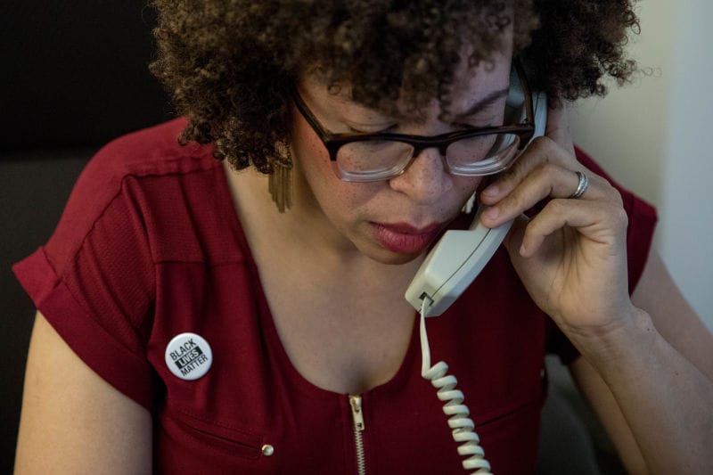 Kirsten Harris-Talley talks on the phone at City Hall.