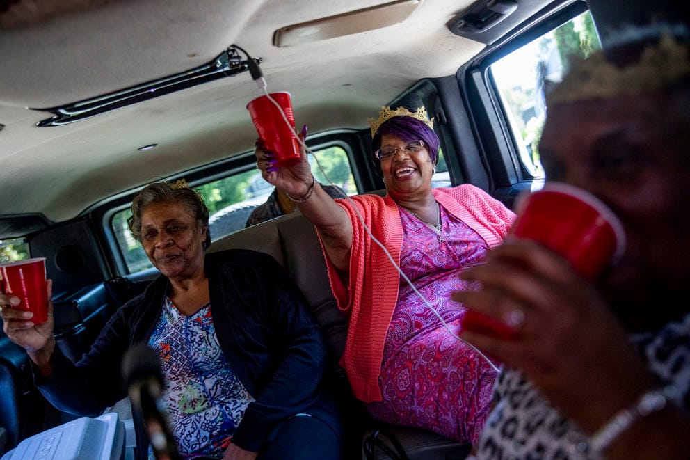 Grandmothers cheers in a stretch Hummer