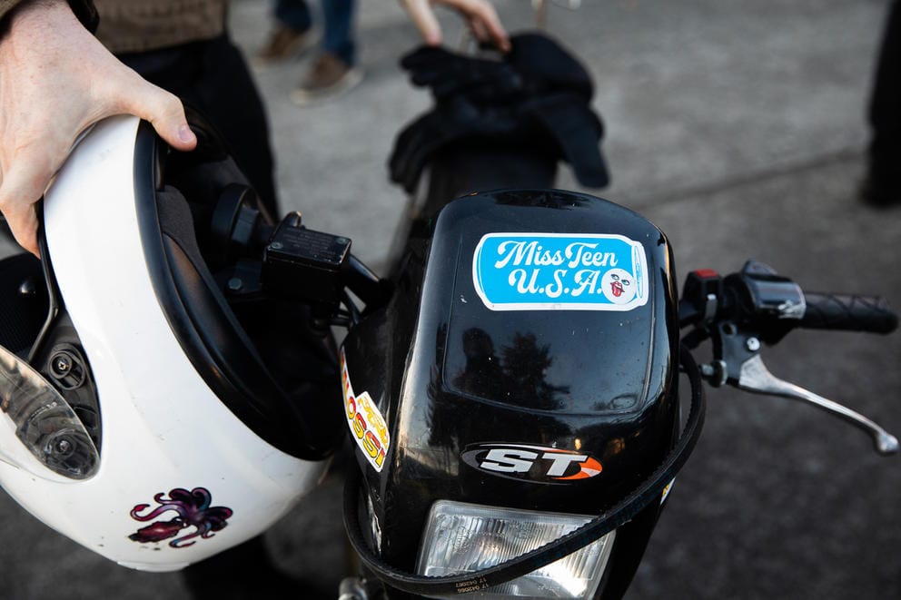 A close up of a helmet and moped handles.