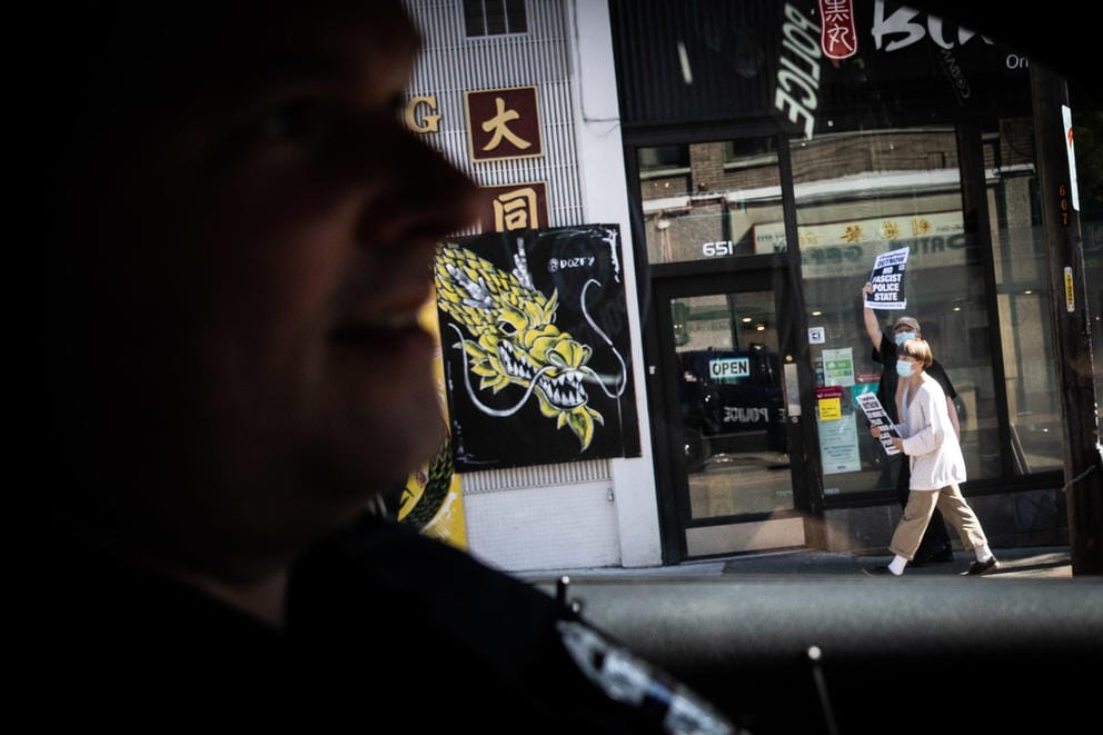 Police drive past protesters