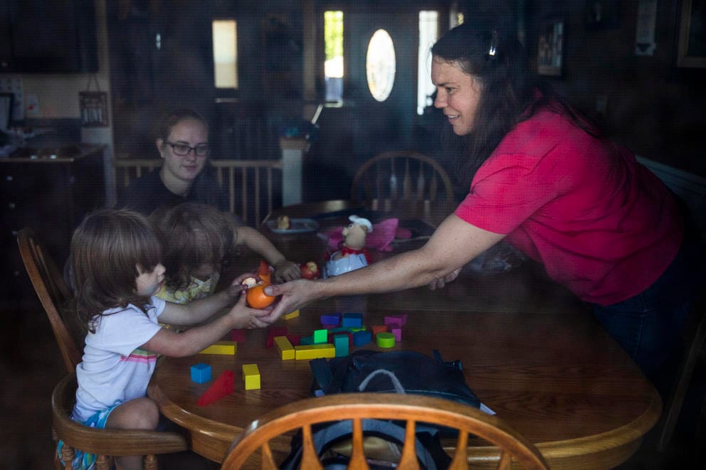 Cathy Apgar prepares a snack around a kitchen table