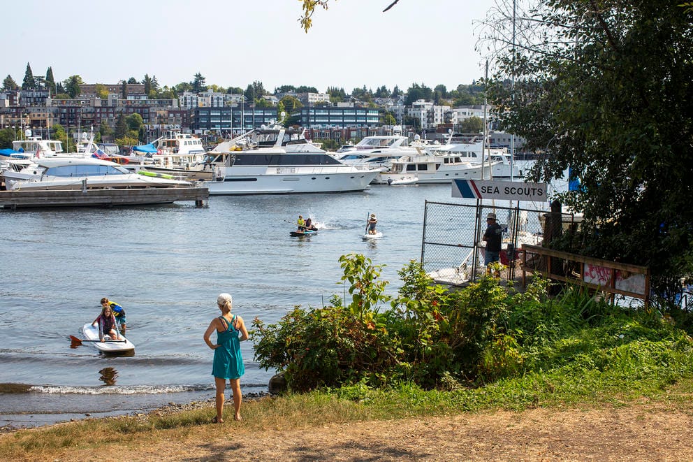 Alisa McKenzie watches her cousins from the shore of Waterway 18, as they play in Lake Union.