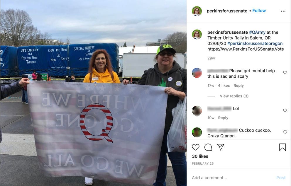 Facebook screengrab of Jo Rae Perkins posing with a QAnon banner
