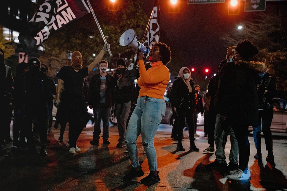 A march organizer addresses the crowd