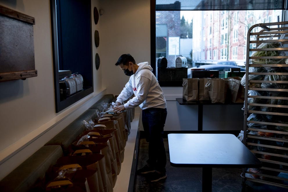 Roz Edison in empty restaurant, packing bags of food