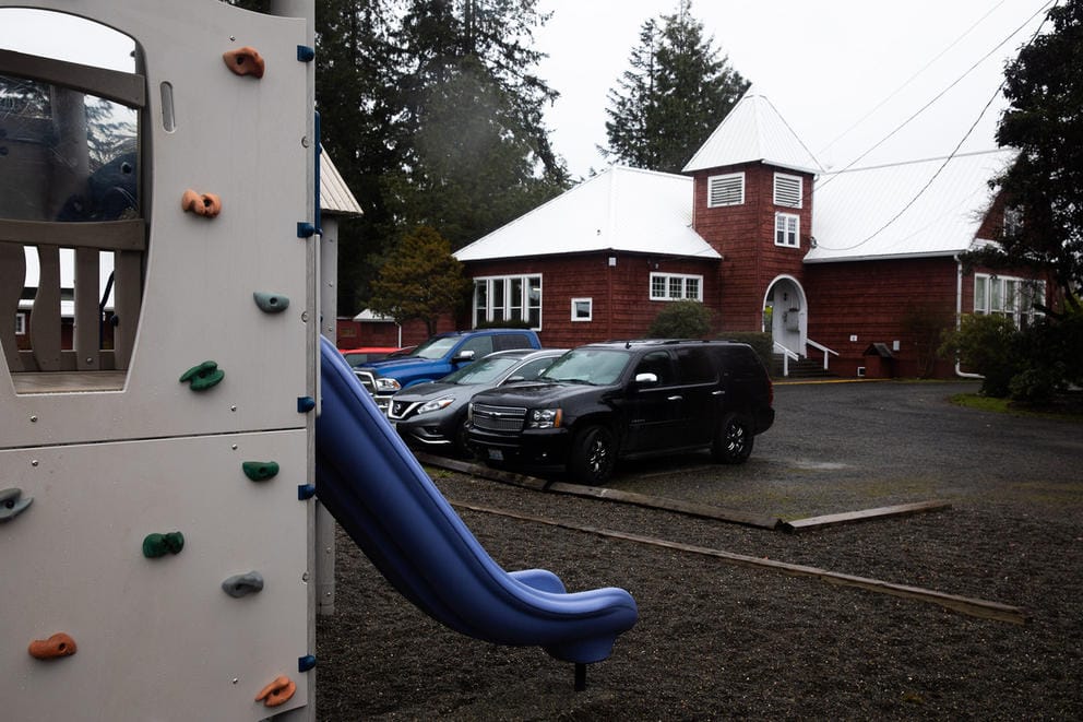 A playground is shown with a school in background