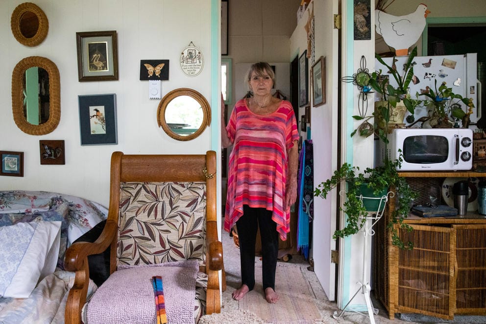 A woman stands in a doorway