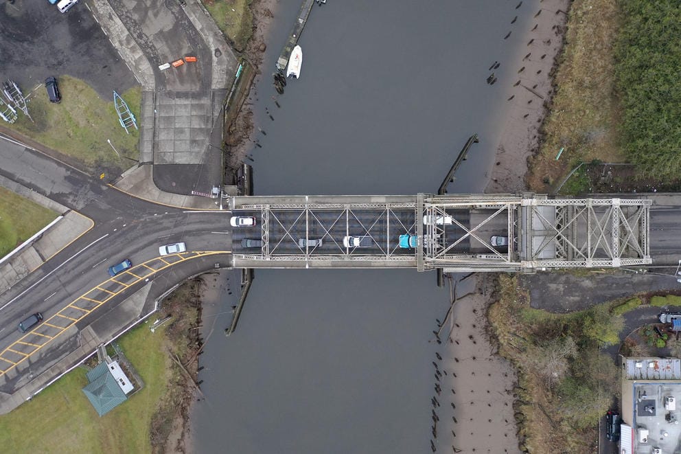 A bridge across the Wishkah River as seen from directly above.