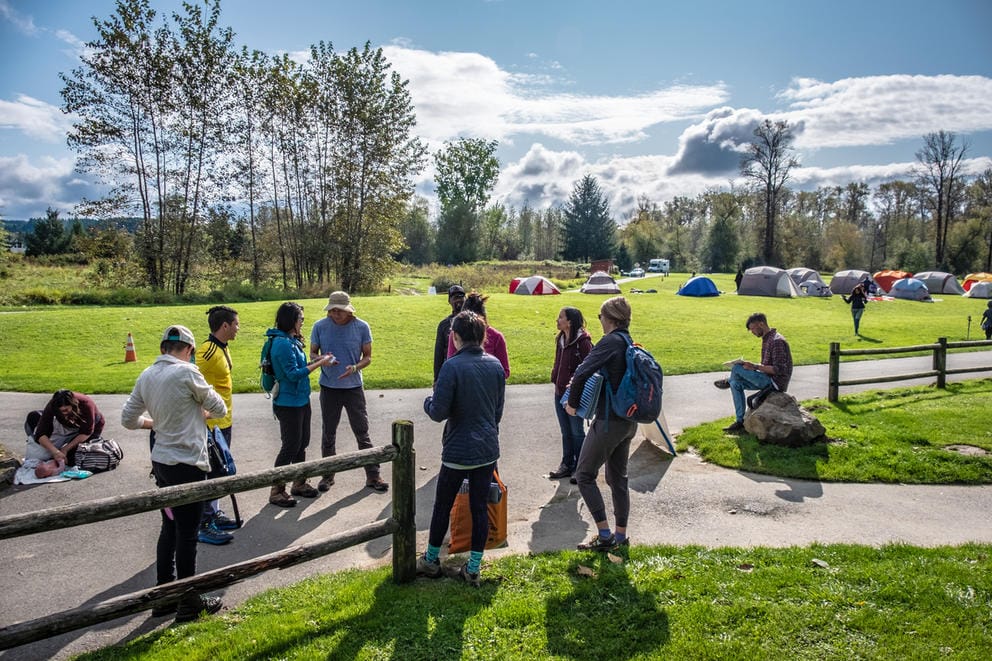 A group of campers talking in an open park