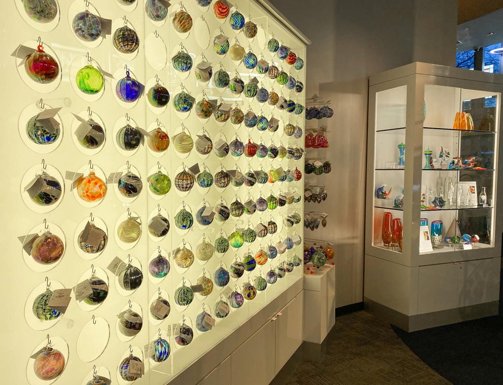 photo of a lit wall showcasing many rows of spherical glass ornaments