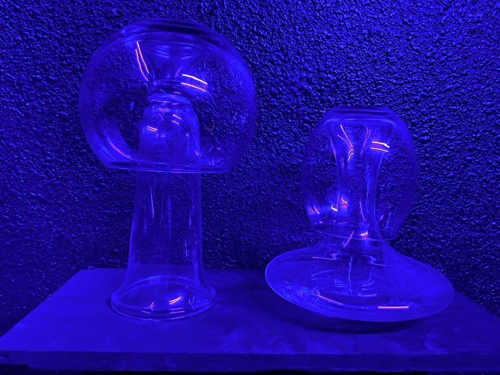 an indigo-lit scene of glass that resembles jellyfish