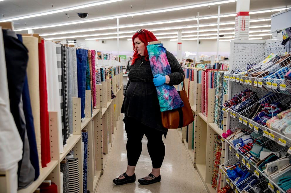 A customer looks for fabric in store to make masks