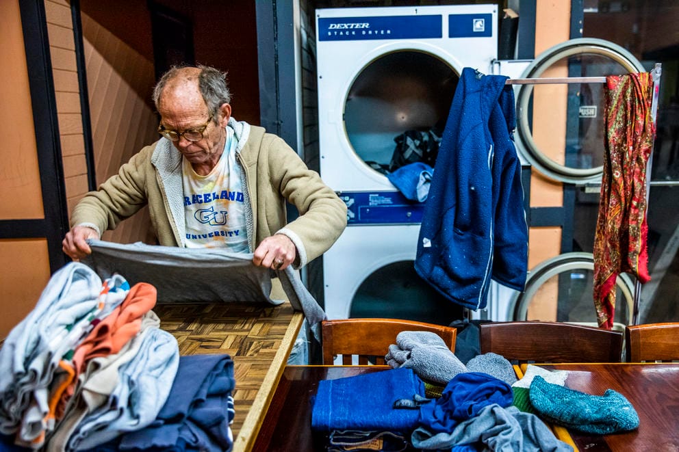 Alan Sutherland, 64, of Seattle does his laundry at King Donuts in Rainier Beach on Sunday, Nov. 18, 2018. Sutherland says he comes every Sunday to do his laundry at King Donuts.