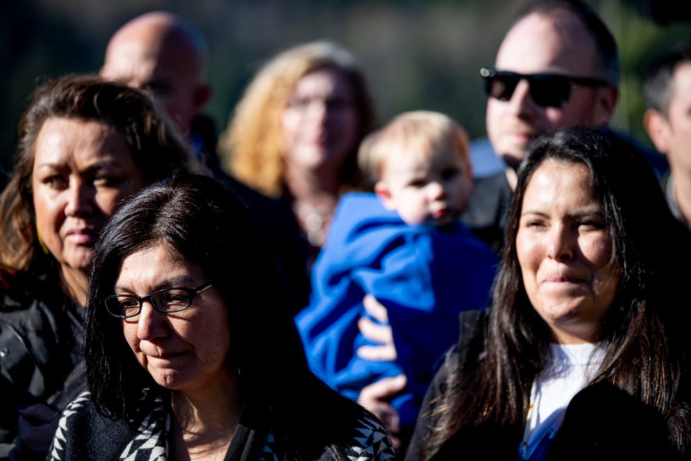 People listen to a press conference