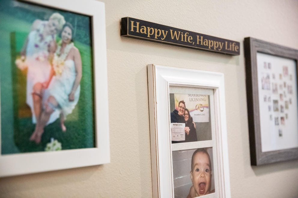 Framed family photos and a sign reading
