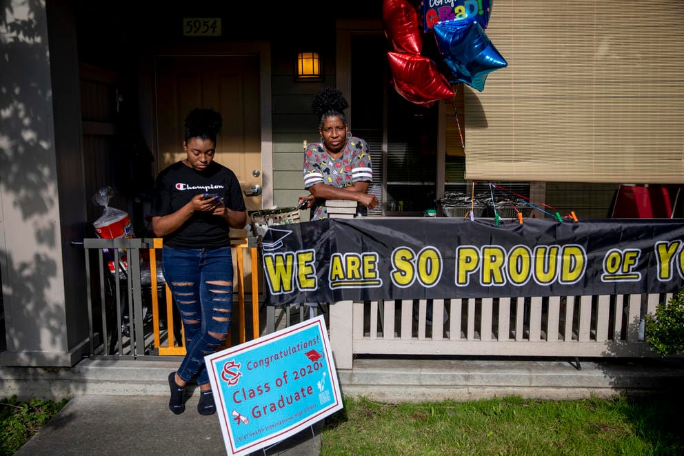Camaree McGhee texts on her phone next to her mother Andrea Haynes