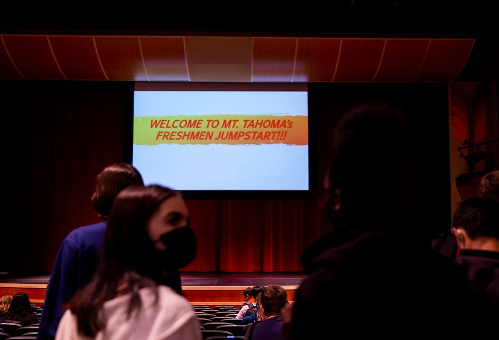 Students wearing masks in an auditorium