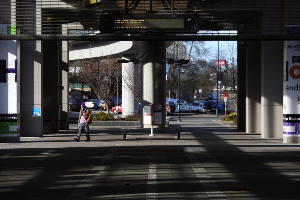 man walks underneath the mount baker station platform