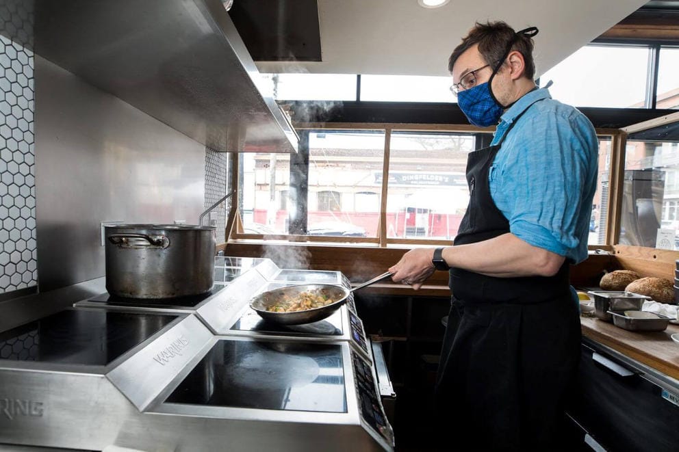 A chef cooking at a stove